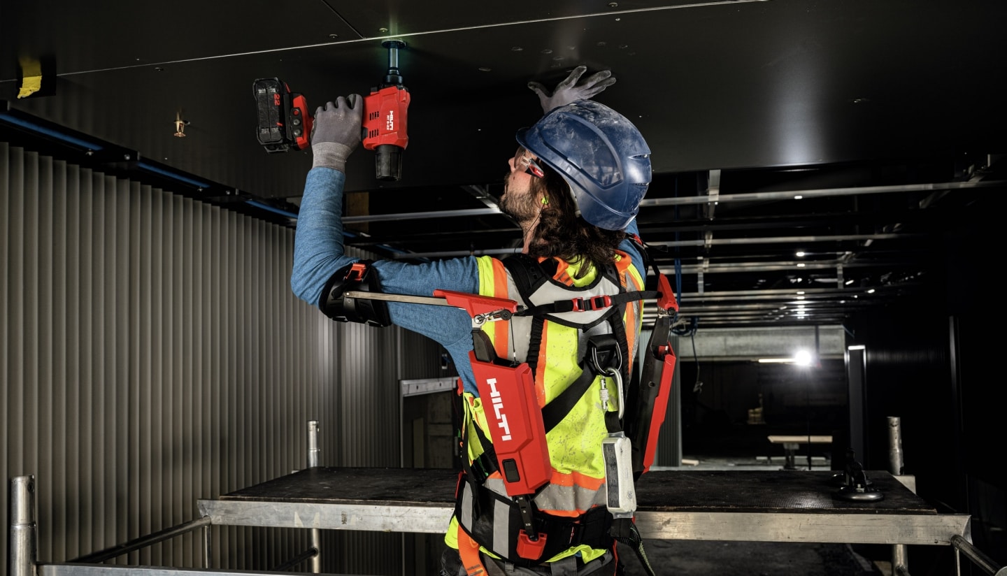 Worker using the EXO-S to assist with overhead work